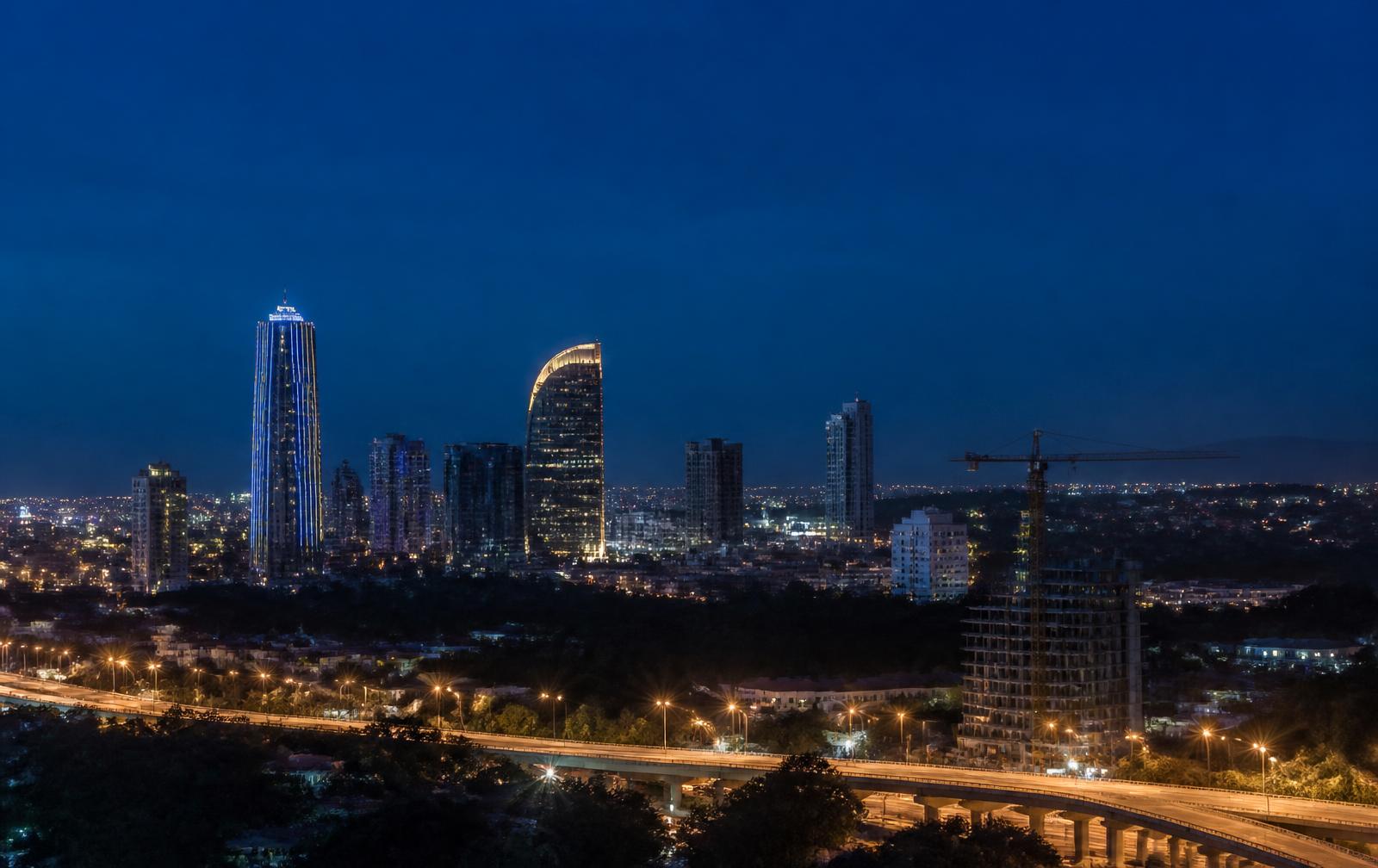A modern East African city skyline at blue hour